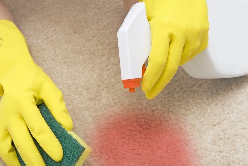 Carpet cleaning technician preparing equipment with safety focus