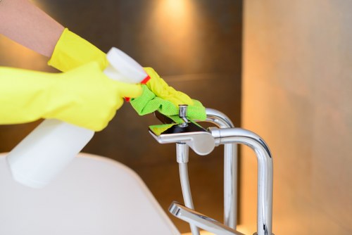 Technician cleaning a fabric sofa with upholstery equipment